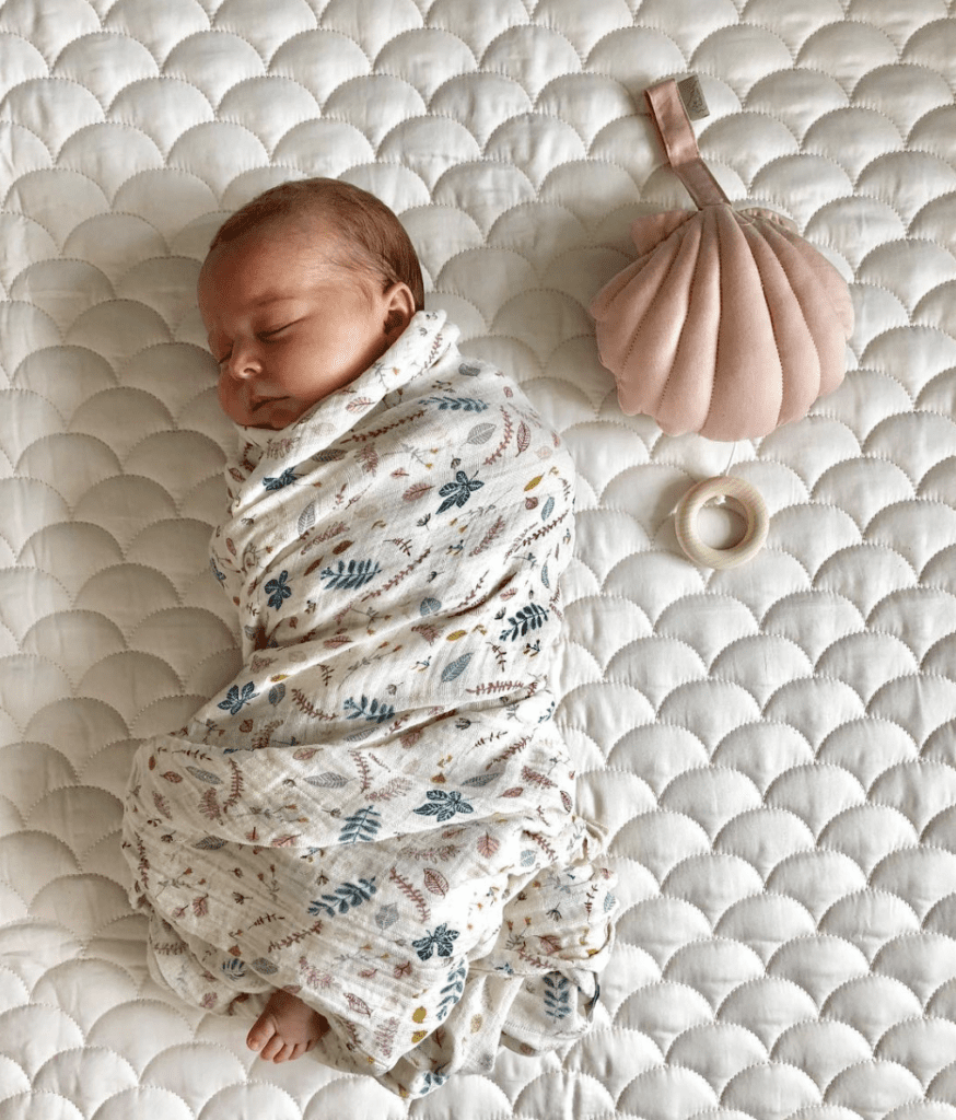 Baby swaddled in organic muslin wrap